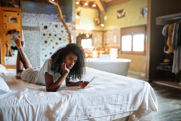 Woman on the bed with mobile phone