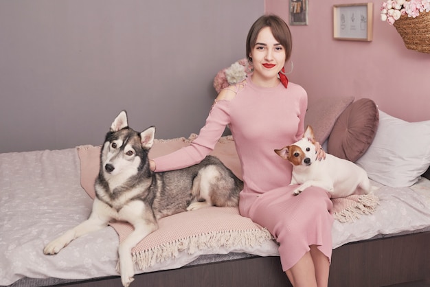 Woman in bedroom. Cozy morning. Woman with dog at home