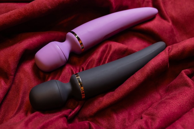 Woman in bedroom holding vibrator in hand