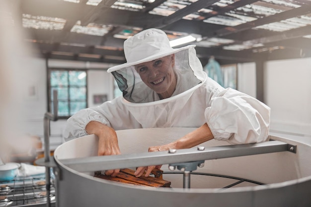 Woman beekeeper and workshop bee farming for honey and natural product farm and small business owner with hive maintenance Organic bees and safety suit elderly person smile in portrait