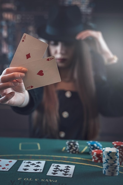 Woman before winning at poker game with two aces in hand at gaming table Luck and fortune