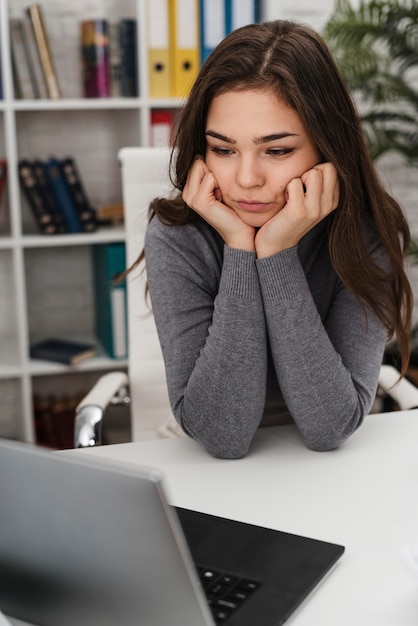 Woman being bored while working from home