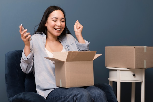 Woman being happy about her online purchase she received