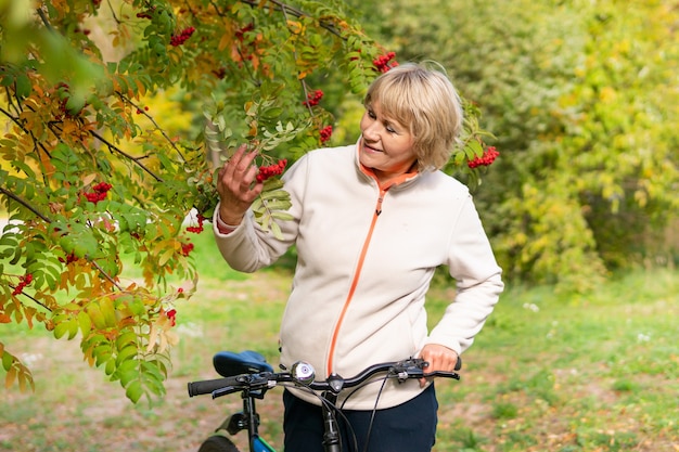 A woman on a Bicycle rides on the road in the city Park