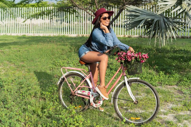Woman on a bicycle setting off for a tropical adventure