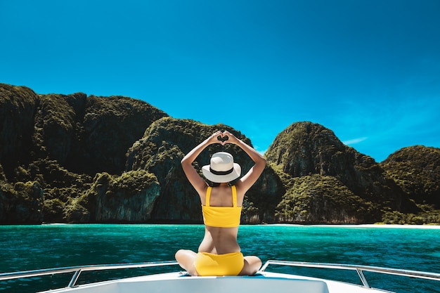 Woman in bikini sitting on a boat