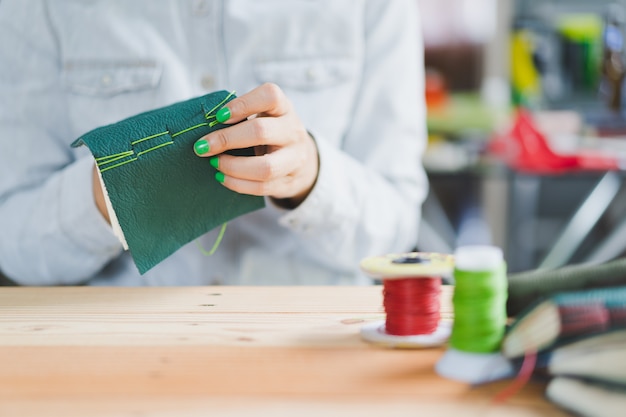 Woman binding green genuine leather handmade notebook