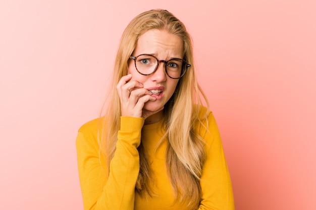 Woman biting fingernails in studio