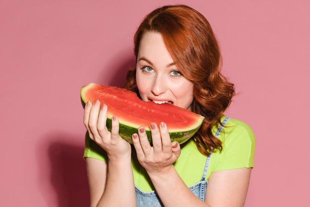 Woman biting into a slice of watermelon