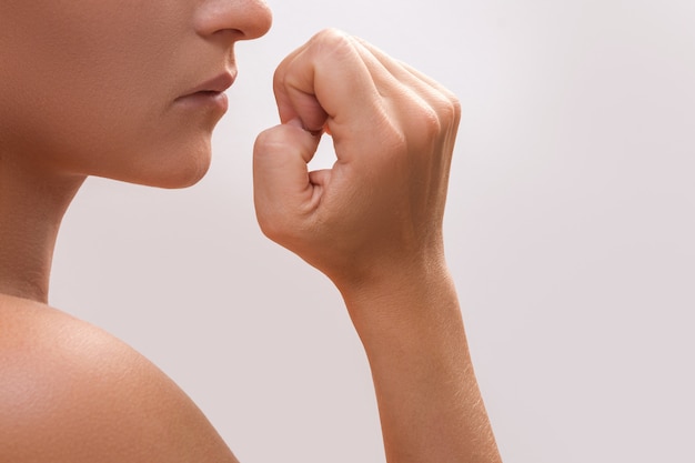 woman bitting her fingers
