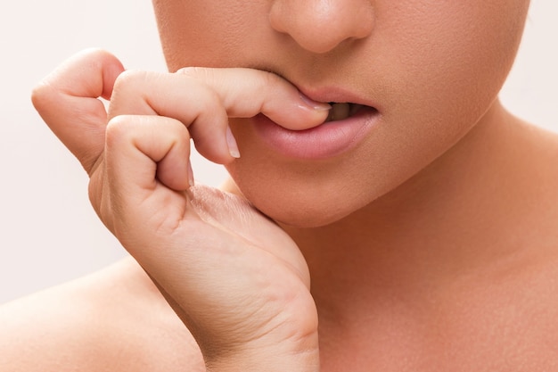 woman bitting her fingers