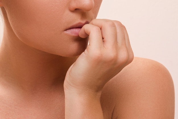 woman bitting her fingers
