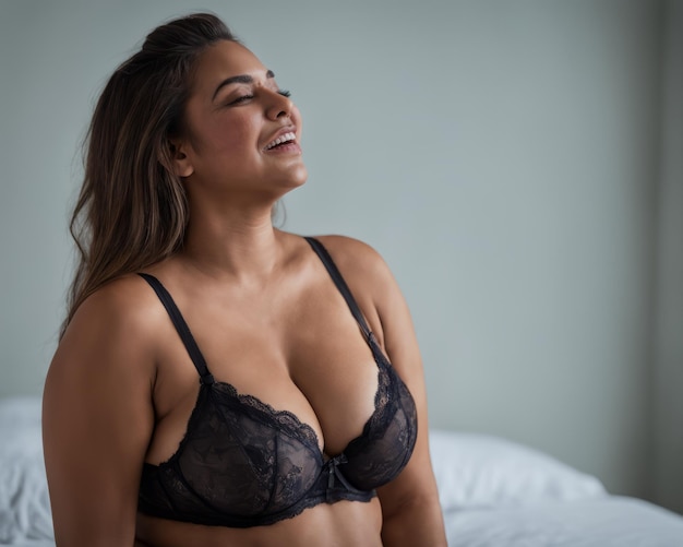 A woman in a black bra and panties smiling