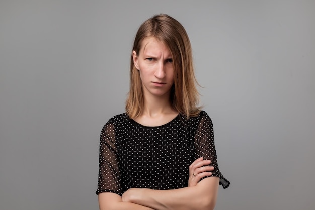 Woman in black clothes being dissatisfied with something feels tired and exhausted