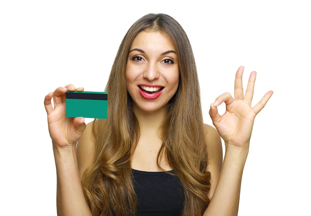 Photo woman in black dress holding bank card and showing ok sign isolated