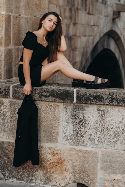 Woman in black dress walking in old city Prague