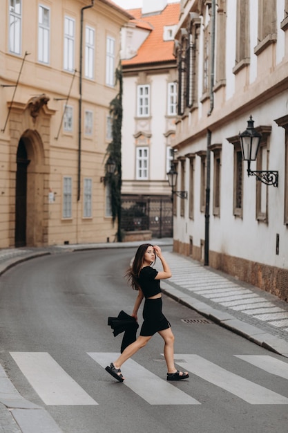 Woman in black dress walking in old city Prague