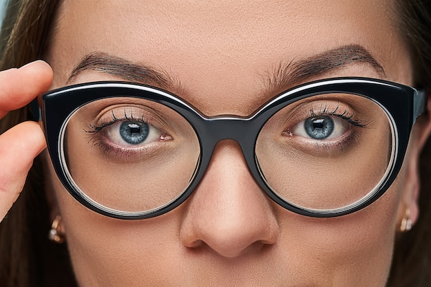 Woman in black frame glasses close up