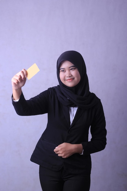 A woman in a black suit is holding a yellow card that says'i'm a female. '