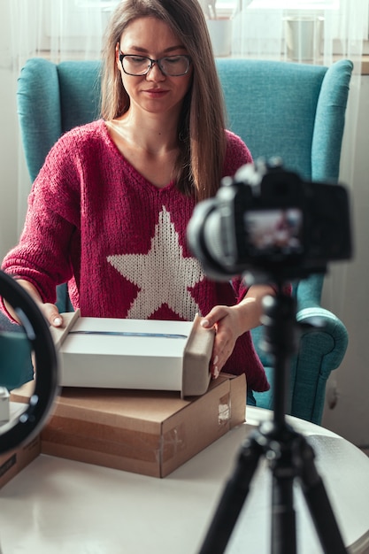 Woman blogger makes video of unpacking gadgets at home