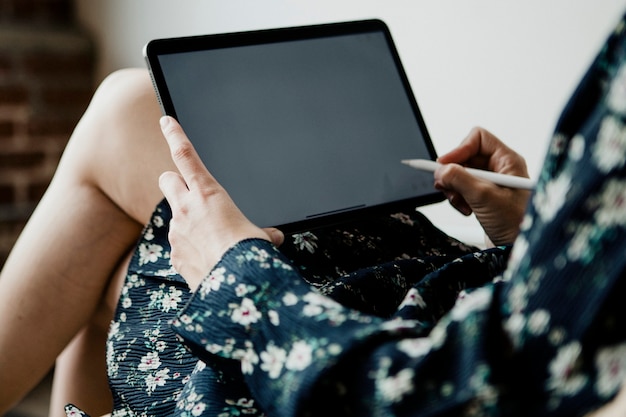 Woman blogging on a digital tablet mockup