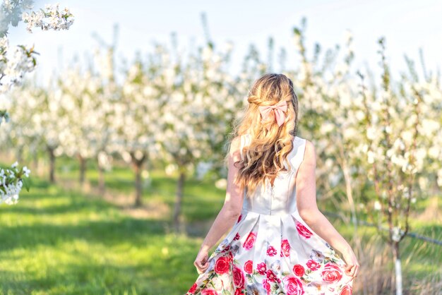 Woman in a blooming cherry orchard in spring