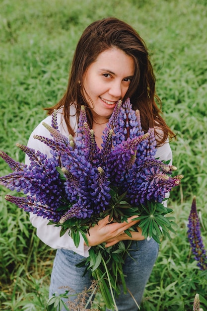 Woman at blooming lupines field