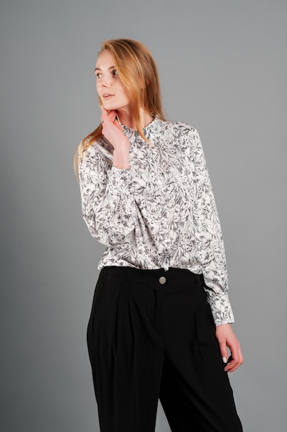 Woman in a blouse and trousers Studio female portrait