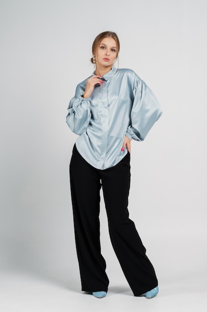 Woman in a blouse and trousers Studio portrait