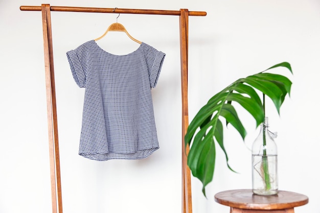 Photo woman blouse with blue blouse cotton on wooden hangers