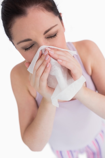 Woman blowing her nose 