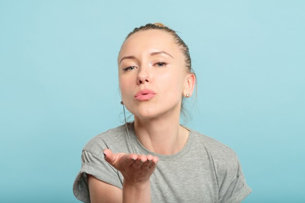 Woman blowing a kiss and sending love. romance and warm feelings concept.