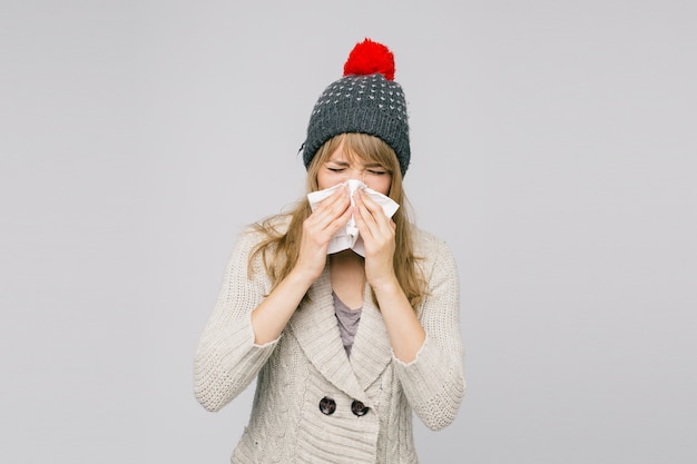 Woman blowing nose