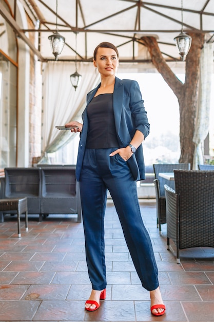 Woman in a blue business suit in a coffee place