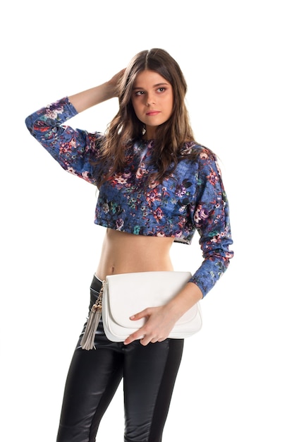Woman in blue crop top. Young girl touches her hair. Cotton top with floral print. Beautiful model wears fashionable clothes.