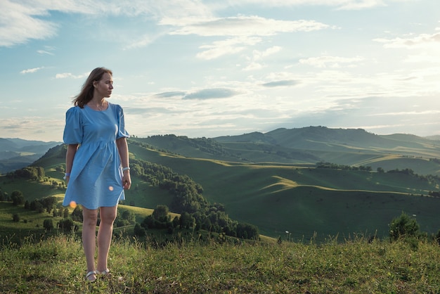 Woman in blue dress in altai mountain