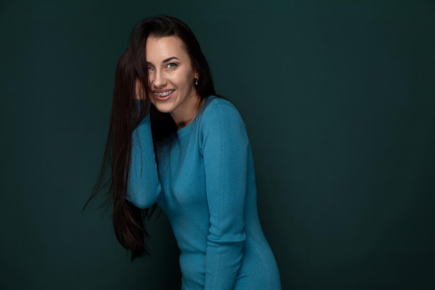 Woman in blue dress posing for picture