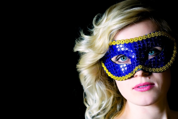 Woman in blue eye mask with bare shoulders