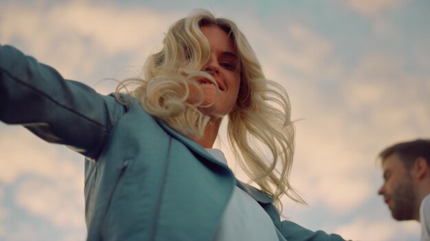 A woman in a blue jacket smiles at the camera and smiles.