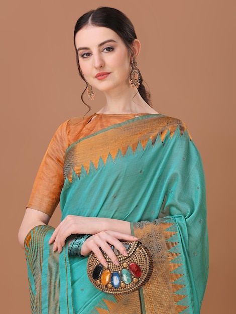 A woman in a blue saree with a gold ring in the middle