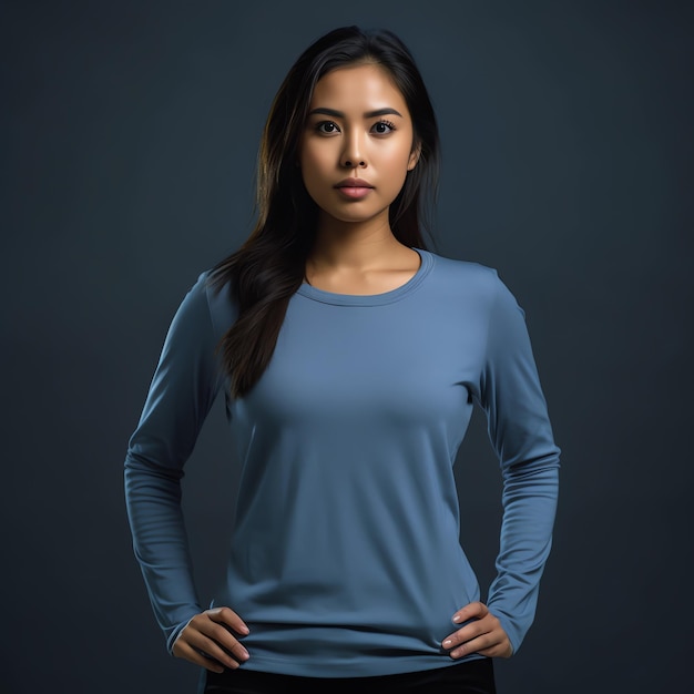 A woman in a blue shirt with a logo on the front of her shirt