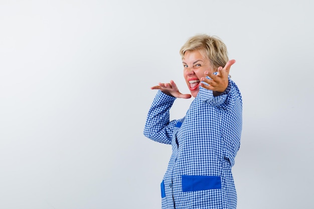 Woman in blue uniform dancing on white background