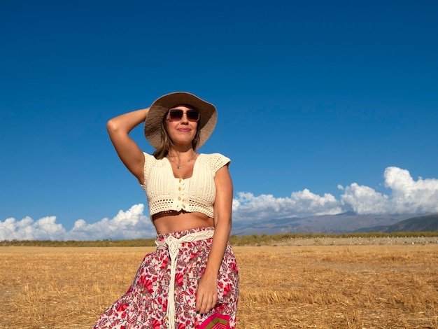 Woman in bohemian clothes in field