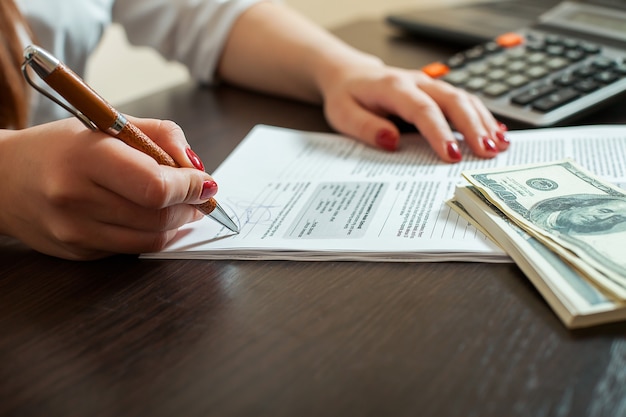 woman bookkeeper signs accounting documents