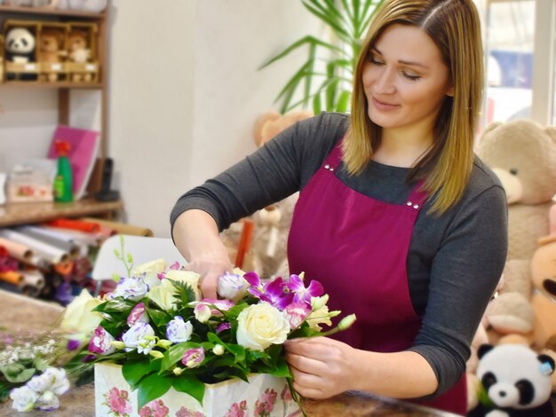 女性と花の花束。フラワーショップのための花。花束ディレクトリフラワーショップ。