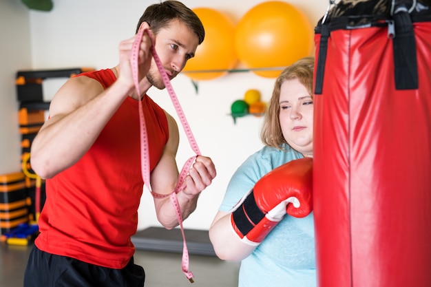 Woman boxing with her coach