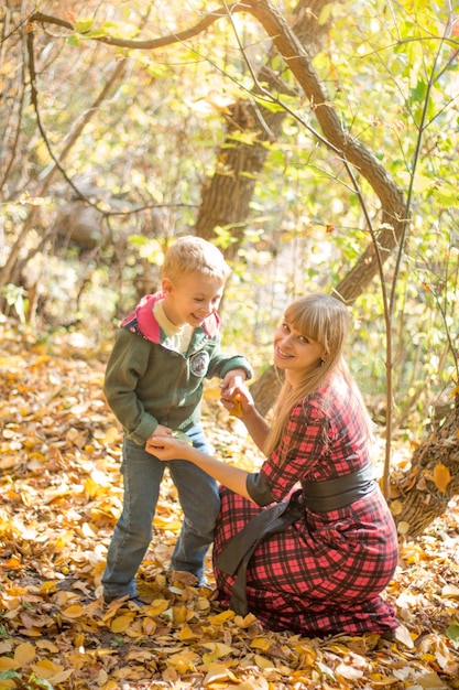 A woman and a boy are playing in the woods