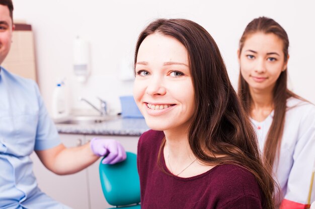 Woman in braces at the dentist office, portrait of patient