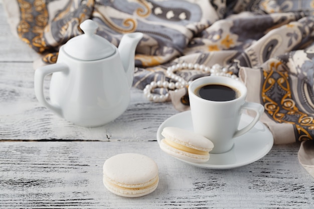 Woman breakfast with shawl and white macaroons