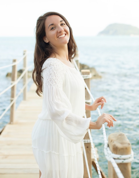 woman on the bridge near sea